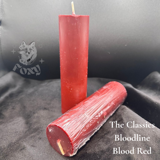 Bloodline blood red paraffin dripping pillar candles, labelled, on black velvet
