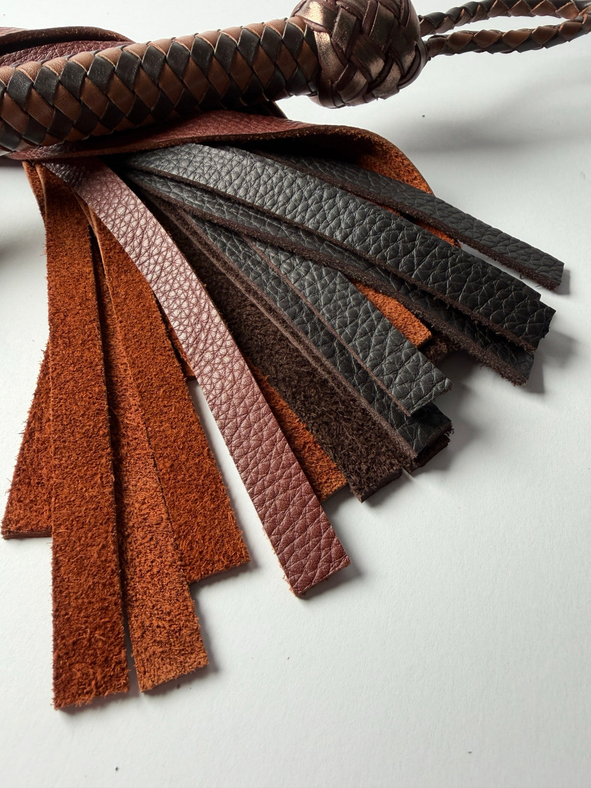 Oloroso's whisky and chocolate floater cowhide fall tips fanned out, showing grain and flesh side
