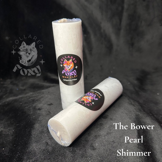 Pearl white shimmer wax play candles, labelled, on black velvet