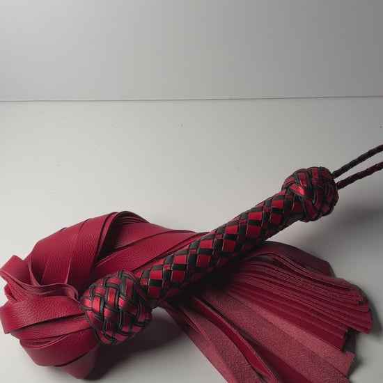 Video of the Vermilion flogger, red cowhide with a red and black diamond braid handle