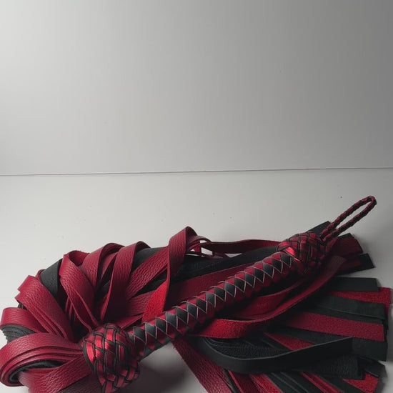 Video of the Garnet flogger, red and black floater cowhide with a metallic red and black braided handle