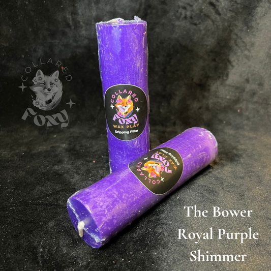 Royal Purple shimmer wax play candles, labelled, on black velvet
