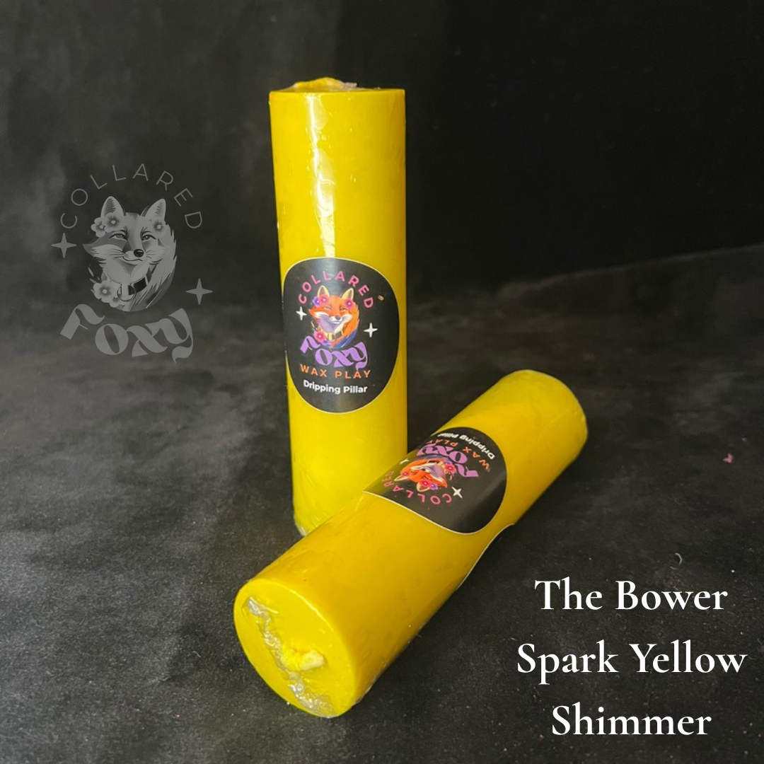 Spark Yellow shimmer wax play candles, labelled, on black velvet