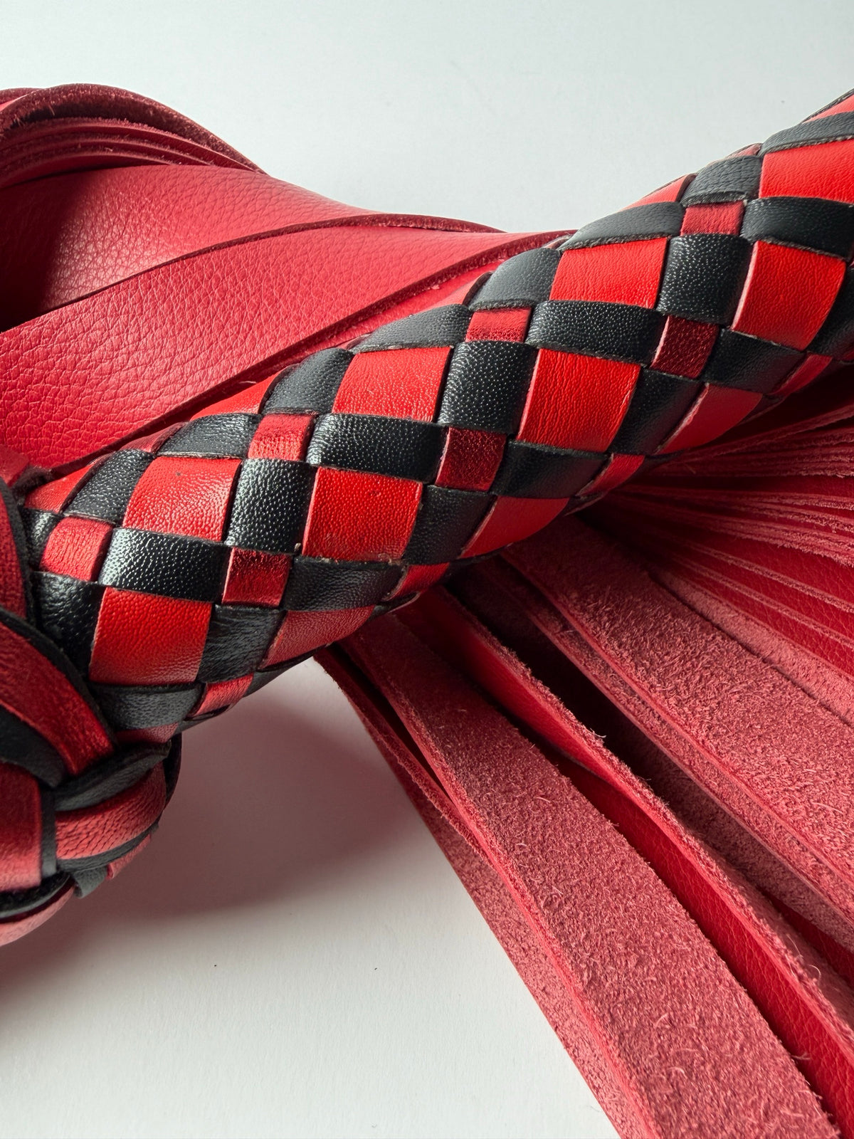 Close up of the red, metallic red and black diamond braid on the Vermilion handle